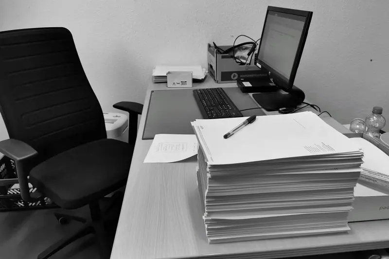 A school administrator working at a computer in an office